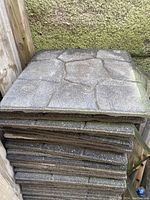 Stack of rubber tiles showing top surfaces and side profile