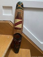 Full view of the wooden tiki sign showing overall length and design placement