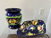 Pair of cobalt blue Maling pottery pieces, a bowl and a planter, shown together on a clear base.