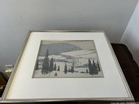 Frontal view of framed watercolor painting on table surface