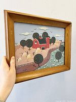 Framed folk art oil painting depicting farm scene with red barn, trees, hay bales, pond with ducks, and rural landscape.