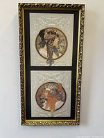 Full shot of framed pair showing ornate gold frame and two circular profile portraits of women in Mucha style art prints.
