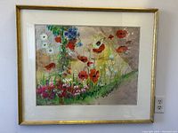 Front view of large wood framed watercolour painting showing colorful flower scene with wildflowers under glass