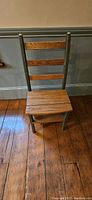 Oak and sage green ladder chair in closed position showing oak seat and rungs with sage green painted frame
