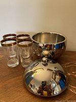 Full set photo showing the Tonpop ice bucket with lid and four gold-trimmed Federal glasses on wood surface.