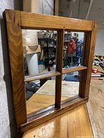 Side angle highlighting the wooden frame thickness and finish.