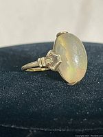 Side view showing stone profile and gold setting