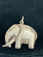 Close-up of the sterling silver elephant pendant showing shape and surface detail.