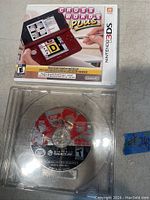Nintendo 3DS game 'Crosswords Plus' with front cover and Nintendo GameCube game disc in clear case beneath it.