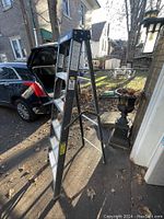 6-foot fiberglass step ladder set up outside showing front angle and steps.