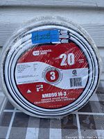 Roll of indoor house wire tightly coiled, showing Canada Wire label with product specs including length, gauge, and type.