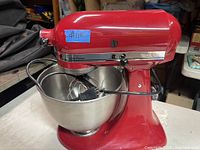 Front view of red KitchenAid tilt-head stand mixer with bowl and cord