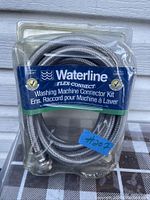 Original packaging of Waterline washing machine connector kit with Flex-Connect flexible braided hoses visible inside clear blister pack.