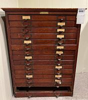 Front view showing multiple horizontal drawers and missing bottom drawer