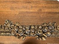 Close-up of central rose and leaf carving