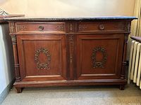 Front view of sideboard showing drawers, doors, columns and marble top