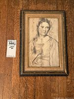 Framed antique print showing the detailed portrait of a young woman by Titian with clear visibility of facial features and upper body.