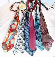 Full view of 6 vintage men's neckties tied and laid side by side showing colors and patterns including abstract, geometric, solid, and paisley.