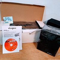 Photo of Discgear Selector 120HD disc holder in original box with additional boxes, software CD, and manuals.