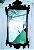 Full frontal view of the full mirror showing frame and reflective surface