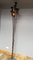 Full view of tall floor lamp showing the 7 tulip glass flower heads and metal curved stalks extending from base upwards.