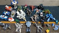 Wide view of entire toy collection showing various Transformers robots and vehicles along with Star Wars figures.