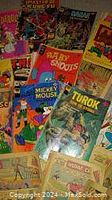 Image of a collection of vintage used comic books with various covers and characters.