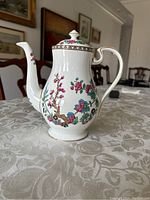 Front angled view of Aynsley Indian Tree oriental design coffee/tea pot showing floral artwork and spout.