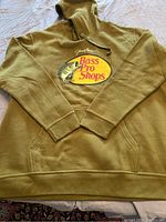 Olive green hoodie sweatshirt laid flat, showing entire garment and hood with drawstrings.