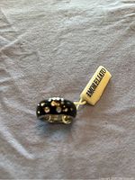 Close-up photo of the Morellato enamel and silver ring with clear stones and the Morellato branded tag attached.