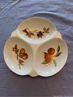 Top view of the tri-section relish dish showing the three separate compartments decorated with fruit motifs (pears, blackberries, oranges)