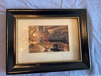 Framed original watercolour painting in black frame with white matting depicting rustic rural scene.