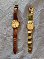 Both watches side by side on fabric background