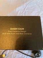 Box side showing 'DASH CAM Dual Cameras Design Built with Front and Rear Cameras' text.