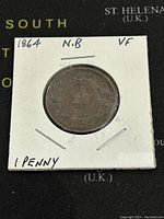 Front side of the 1864 New Brunswick One Cent coin showing the crowned shield design in Very Fine condition.