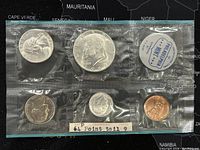 Obverse side of the 1964P US Silver Proof-Like Coin Set showing half dollar, quarter, dime, and penny sealed in original packaging with Philadelphia Mint label stating '64 Point tail 9'.