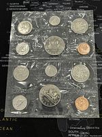 Two complete sets of Canadian coins from 1968 and 1969, sealed in original plastic packaging, showing full coin faces and reverse detail for assessment of condition and completeness.