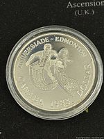 Obverse side of the 1983 Canadian Universiade proof silver dollar coin, showing the athlete and maple leaf design with coin details.