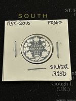 Front side of the coin showing 25 cents denomination and 1935-2010 date with maple leaf design in silver proof condition.