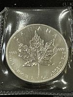 Reverse of the coin showing maple leaf design and purity marks