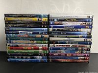 Stack of 30 kids movies DVDs showing titles and condition of cases