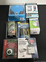 7 electronic and accessory items displayed including headphones, sanitizing station, USB hub, LED bulb, earphones, timer, battery charger