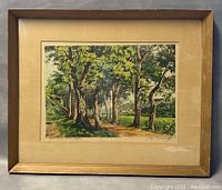 Framed etching showing tree-lined shaded country road with matting and wooden frame, overall size 21x17 inches.