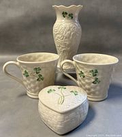 Front-facing photo showing the vase, two mugs, and heart-shaped box with shamrock designs.