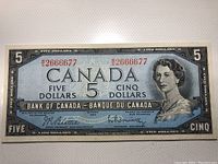 Front side of the 1954 Canadian five dollar banknote showing Queen Elizabeth II and serial number.