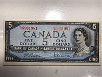 Front side of the 1954 $5 Canadian banknote with Queen Elizabeth II portrait and serial numbers