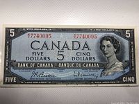 Front of 1954 Canadian $5 bank note showing portrait of Queen Elizabeth II and serial number W7740095.