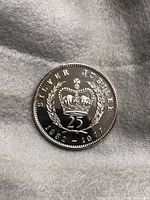 Close-up image of the 1977 Silver Jubilee 25 Pence Coin showcasing the crown, laurels, and inscriptions on the front side.