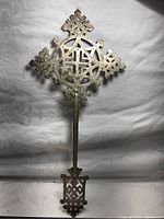 Full view of the Ethiopian blessing cross showing the entire length and symmetrical cross head with cut-out designs.