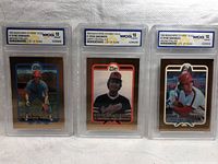 Three Ryne Sandberg baseball cards in protective cases graded WCG 10 Gem Mint, from 1993 Bleachers 23 Karat Gold series, showing front views and gold foil borders.